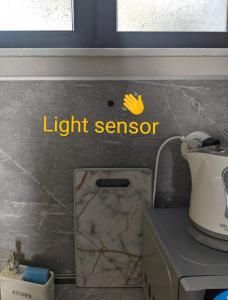 a light sensor sign on the wall of a kitchen at Emanuela Sea And Luxury in Kavala +15 photos