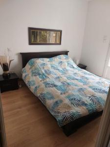 a bedroom with a bed with a colorful comforter at Chambre indépendante avec terrasse privative in Le Revest-le-Eaux