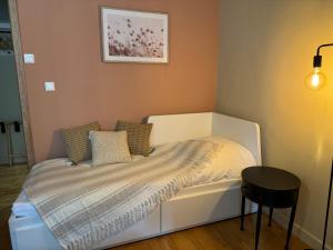 a small bedroom with a bed and a table at La Maison d'Irmine in Sarralbe +11 photos