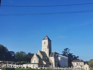 an old church with a tower on top of a cemetery at Jacqueline in Étretat