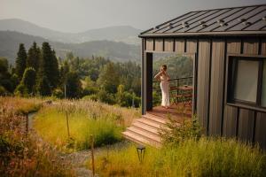 a woman standing on a porch of a building at Mount hotel in Slavske