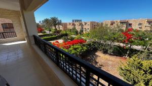 a balcony with flowers and plants on a building at Chalet in Marina 6 District 31 in El Alamein