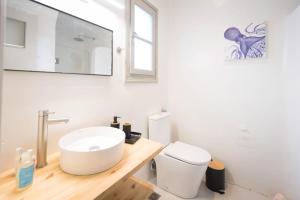 a white bathroom with a sink and a toilet at SWELL S3 new studio in Naousa in Naousa