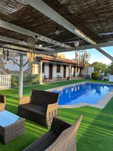 a patio with chairs and a swimming pool at LAR DE SUSA in Pontevedra +79 photos