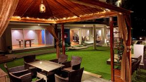 a gazebo with a table and chairs and a pool table at Royal Lodge By Hotel Demanchi in Murree