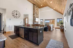 an open kitchen and living room with a stone wall at Private Hot Tub-Free Attraction Tickets-Lake Lookout-Community Indoor & Outdoor Pools in Branson