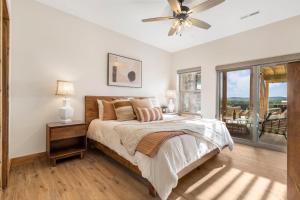 a bedroom with a bed and a ceiling fan at Private Hot Tub-Free Attraction Tickets-Lake Lookout-Community Indoor & Outdoor Pools in Branson