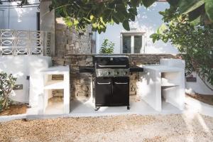 a outdoor kitchen with a stove and a table at SWELL S4 brand new studio in Naousa in Naousa +18 photos