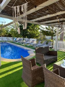 a patio with chairs and a swimming pool at Casa Susa in Poio