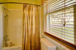 a bathroom with a toilet and a window at Tranquil Bayou Country Home with Pond 8 Mi to Houma in Houma +24 photos