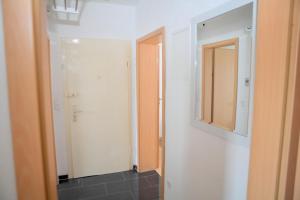 a bathroom with a mirror and a closet at Apartment Am Ring in Bochum