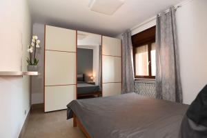 a bedroom with a bed and a mirror at A casa di Tina in Genzano di Roma +34 photos