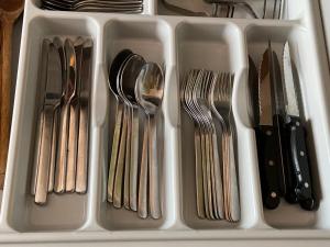 a plastic container filled with utensils in a drawer at Appartamento al Condominio Concordia in Grado +15 photos