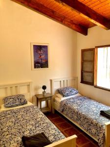 a bedroom with two beds and a window at Villa Bellavista Malaga - Stunning Views - Private in Málaga