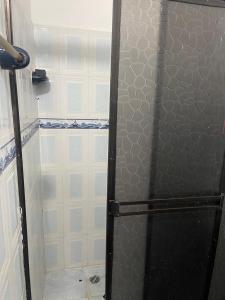 a shower with a glass door in a bathroom at La plata huila in La Plata