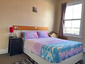 a bedroom with a large bed and a window at Golden Cross Hotel in Waihi