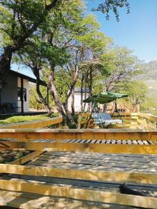a deck with a bench and a gazebo at Tierras Mágicas in Villa Pehuenia +26 photos