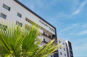 a building with a sign on the side of it at Courtyard by Marriott Hermosillo in Hermosillo