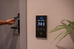 a person is unlocking a door with a remote control at Diol Hotel Ksamil in Ksamil