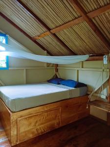 a bunk bed in a room with a roof at La Urraca Loca Hostel in Balgue