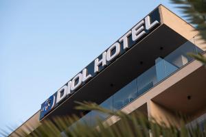 a building with a sign on top of it at Diol Hotel Ksamil in Ksamil