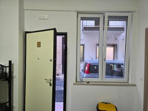 a door to a room with a car in a building at Da Massimo 1 in Marina di Schiavonea