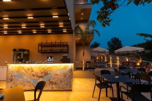 a restaurant with tables and chairs and a map on the wall at Diol Hotel Ksamil in Ksamil