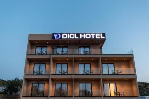 a hotel with a sign on top of it at Diol Hotel Ksamil in Ksamil