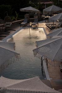 a pool of water with chairs and tables at Diol Hotel Ksamil in Ksamil