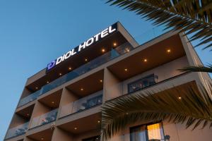a hotel with a sign on the top of it at Diol Hotel Ksamil in Ksamil