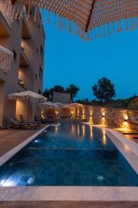 a swimming pool in a hotel at night at Diol Hotel Ksamil in Ksamil