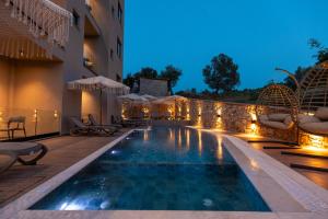 a pool at a hotel at night at Diol Hotel Ksamil in Ksamil