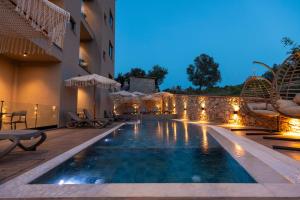 a pool at a hotel at night with lights at Diol Hotel Ksamil in Ksamil