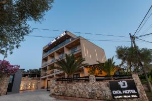 a hotel with a sign in front of it at Diol Hotel Ksamil in Ksamil