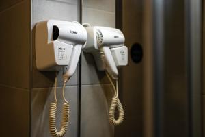 three phones are hanging on a wall in a bathroom at Bed & Breakfast Blanc in Pučišća