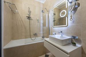 a bathroom with a sink and a shower and a tub at Bed & Breakfast Blanc in Pučišća