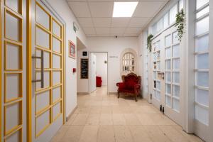 a corridor with a red chair in a hallway at Bed & Breakfast Blanc in Pučišća
