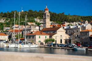 a group of boats docked in a harbor with a town at Bed & Breakfast Blanc in Pučišća