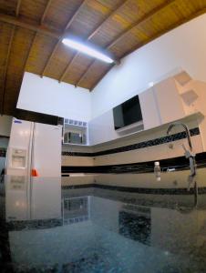 a room with a pool of water with a train on the wall at Azulejo - Guest House in Medellín