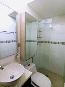a bathroom with a sink and a toilet and a shower at Azulejo - Guest House in Medellín