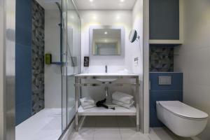 a bathroom with a sink and a toilet at Best Western Plus Ajaccio Amirauté in Ajaccio