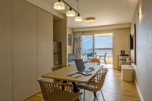 a dining room with a table with a laptop on it at Best Western Plus Ajaccio Amirauté in Ajaccio