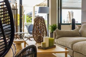 a living room with a couch and a table at Best Western Plus Ajaccio Amirauté in Ajaccio