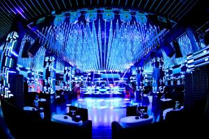 a room with three sinks and blue lights at 555 Hotel Clubbing Adults Only in Marrakesh