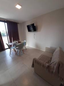 a living room with a couch and a table at Apart El Carau in Corrientes +14 photos