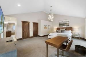a bedroom with a bed and a desk in it at Heber Hideaway Exquisite Home with Hot Tub in Heber City