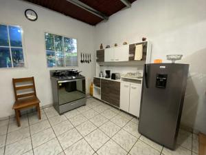 a kitchen with a refrigerator and a chair in it at Casa Juayúa in Juayúa