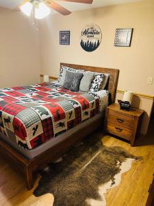 a bedroom with a bed and a nightstand with a bed sidx sidx at The Barn in Asheville
