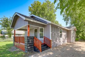 a small house with a front porch and orange railing at Remodeled Tulsa House with Yard about 4 Mi to Downtown! in Tulsa
