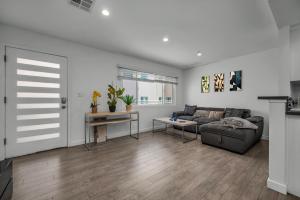a living room with a couch and a table at Stylish One-Bedroom Retreat with Central AC & Free Parking in the Heart of Hollywood in Los Angeles +5 photos